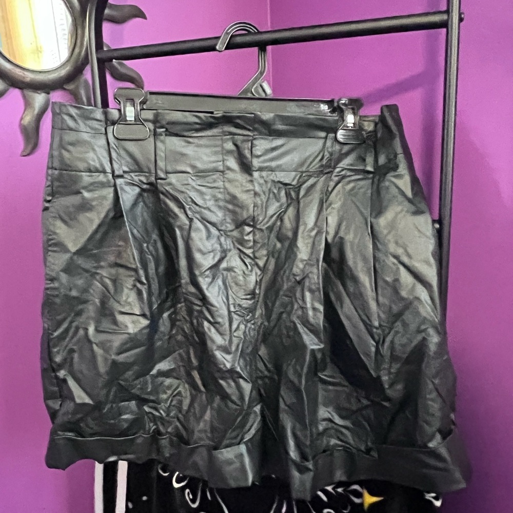Black leather shorts with zipper fly and button closure
